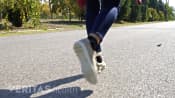 Posterior view of woman walking in a park.
