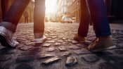Walking feet on a cobblestone street.