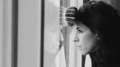Woman gazing sadly out of the window