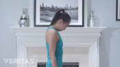 Woman doing the flexion neck stretch