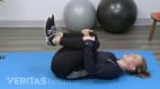 Women doing a knees to chest stretch