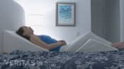 Woman sleeping with a wedge pillow underneath her back and legs.