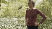 Woman taking a breath on an outdoor walk.
