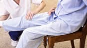 Physical therapist working with a patient&#039;s knee