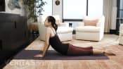 Woman lying prone performing the press up stretch.