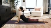 Woman lying prone performing the press up stretch.