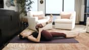 Woman performing the single knee-to-chest isometric stretch for sacroiliac joint pain