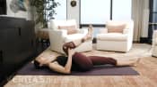 Woman performing the single knee-to-chest isometric stretch for sacroiliac joint pain