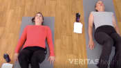 Woman laying on the floor preparing to do the supine hamstring stretch
