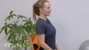 Woman speaking to the camera about using a lumbar roll.