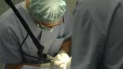 Doctors performing surgery in an operating room
