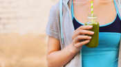 Woman drinking a green smoothie.