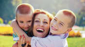 Two young, happy boys with their mom.
