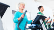 Woman on an elliptical trainer at the gym.