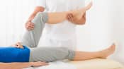 Physical therapist working with a patient&#039;s knee