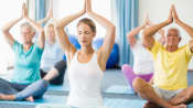 Yoga class doing the seated prayer pose
