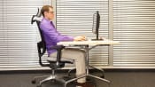 Man sitting ergonomically correct in his office chair.