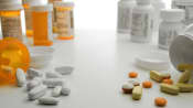 Prescription pills and bottles on the left, over the counter pills and bottles on the right