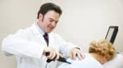 Women getting chiropractic treatment on upper back