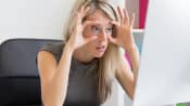 Woman trying to stay awake at her computer