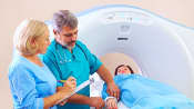 Medical staff preparing patient for CT scan