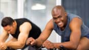 Man biking on a stationary bike at the gym.