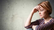 Young teenager sitting down looking depressed