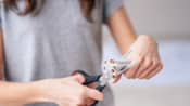 Woman cutting up cigarettes