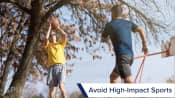 Two men playing basketball outdoors