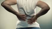 Woman grabbing her back in pain