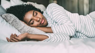 Woman asleep on her side.