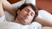 Man asleep peacefully in his comfortable bed.