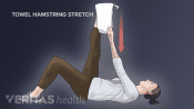 Woman performing the supine hamstring towel stretch for sciatica pain relief