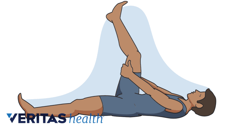 A man doing hamstring stretch lying on the floor.