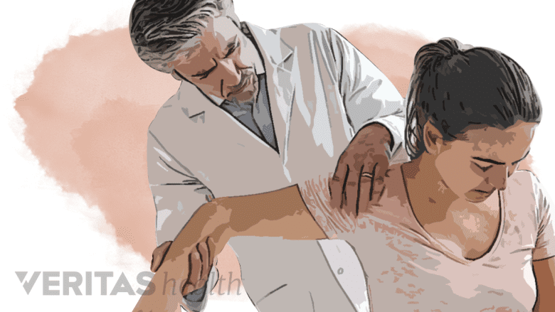 A doctor performing physical exam on a woman.